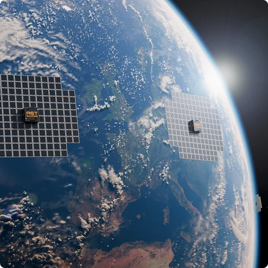 Two AST SpaceMobile satellites with large solar arrays orbiting above Earth