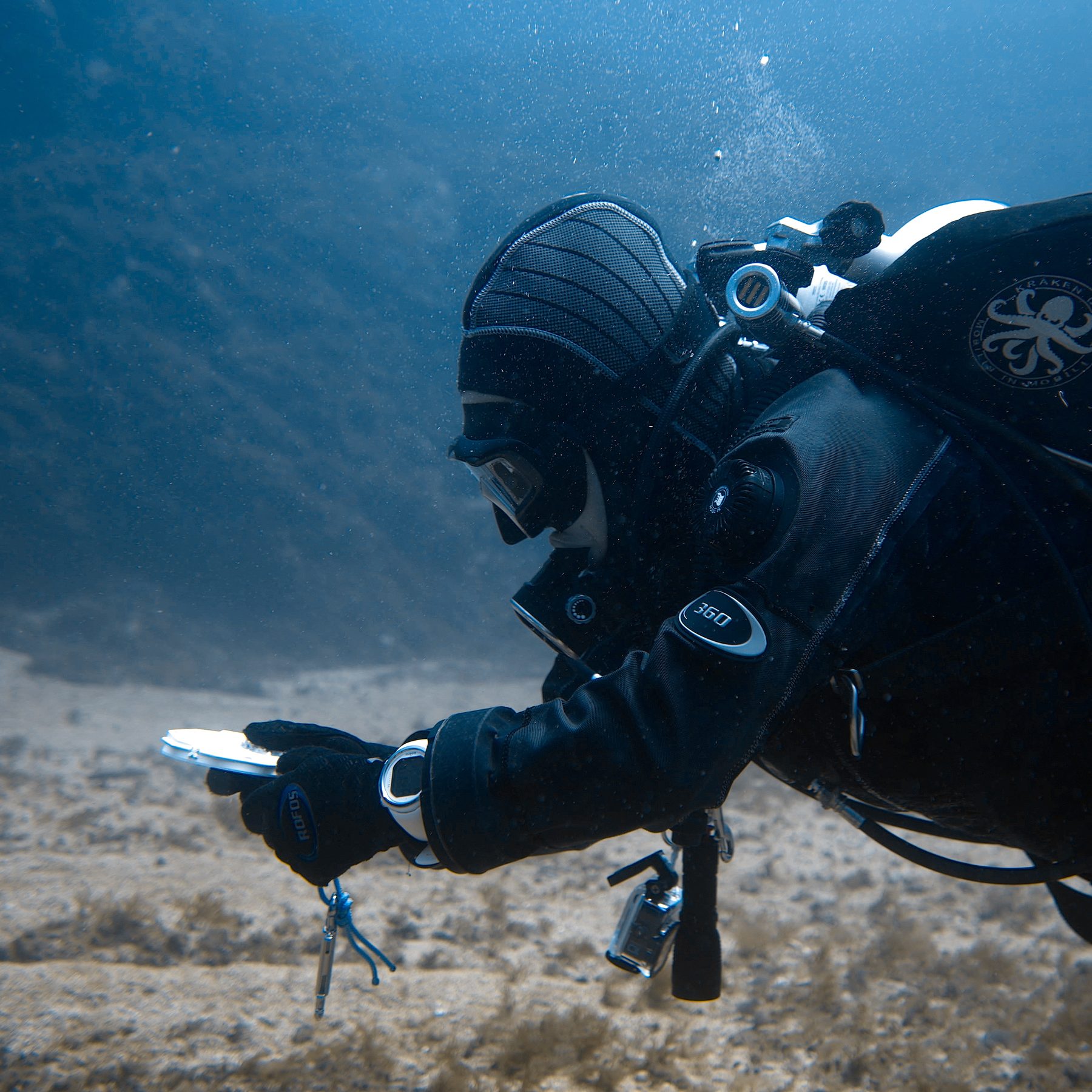 Diver holding the patented octagonal map underwater